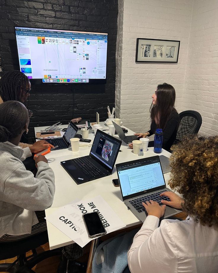 Developers collaborating together on laptops during a team session