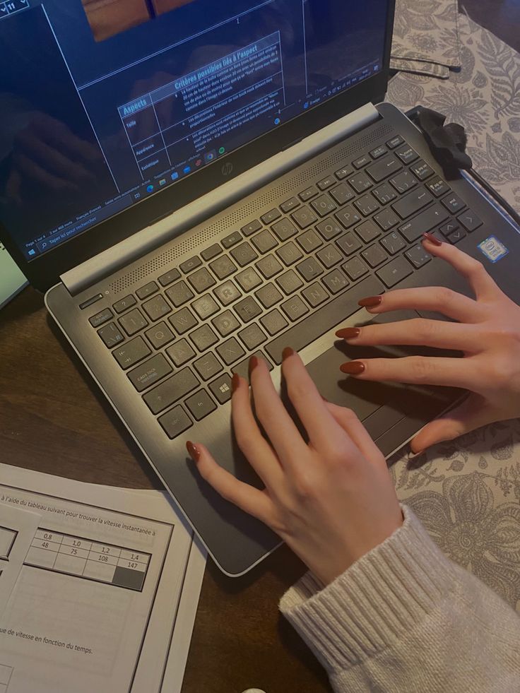 Person typing a prompt into an AI chatbot interface on a laptop